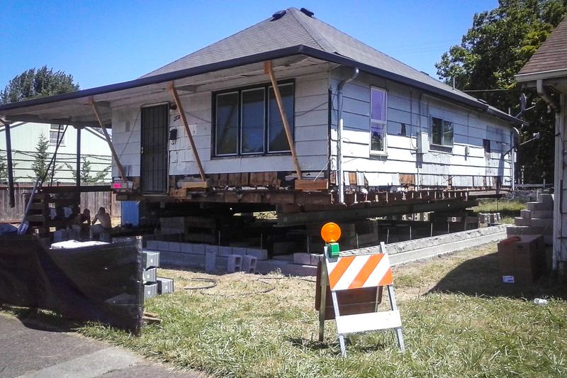 A house is jacked up to make room for a new foundation